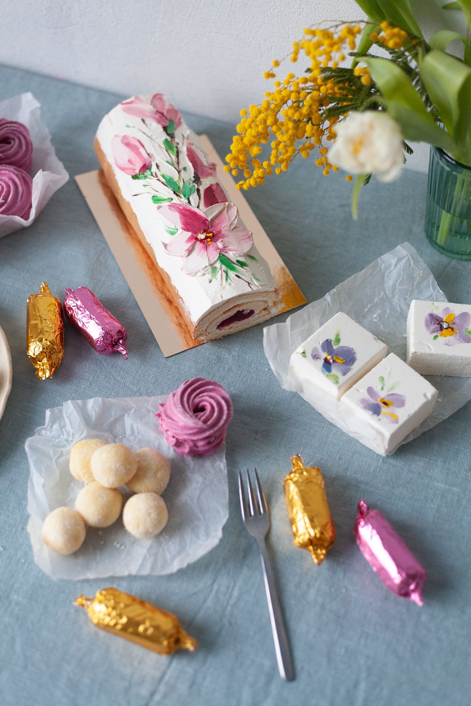 Floral cakes and sweets on a blue table
