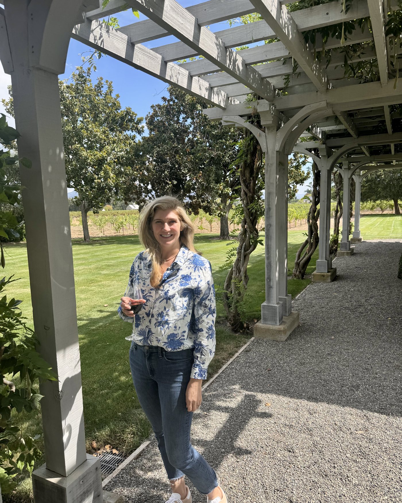 Paige standing beneath a garden pergola